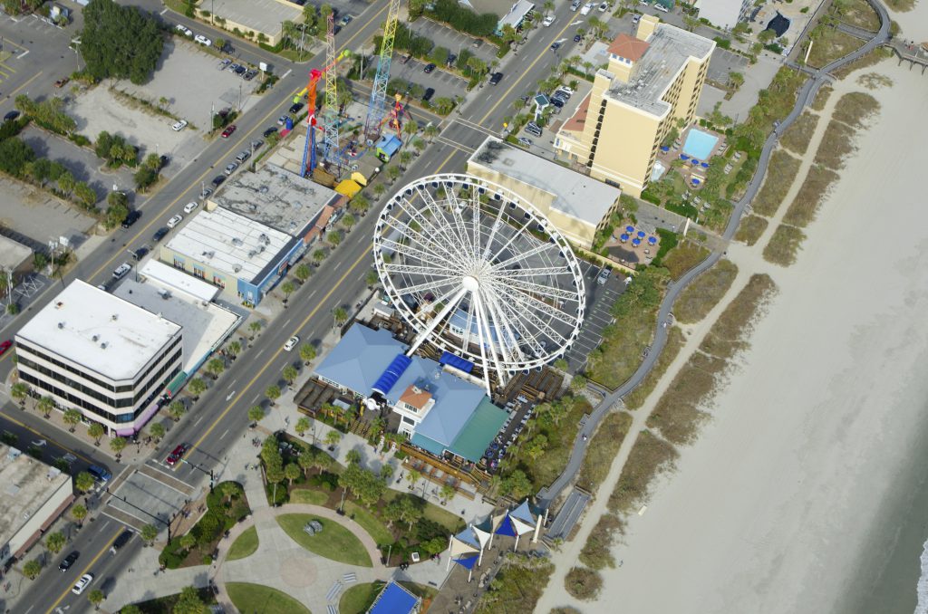 Ariel Picture of The Boardwalk in Myrtle Beach with the skywheel and other fun rides.