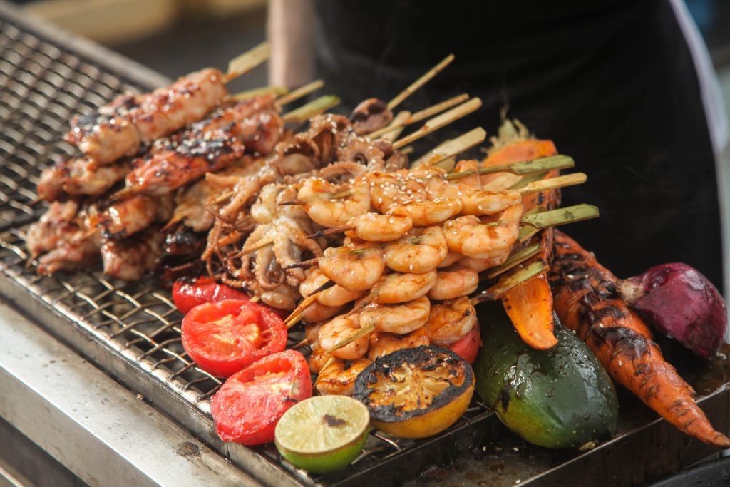 Fresh grilled shrimp and octopus kebabs with lemon tomato and avocado